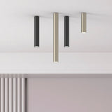 Rose Cylinder Recessed Downlight in matt polished brass, shown among black and brass ceiling-mounted cylinder downlights of varying lengths against a white ceiling.