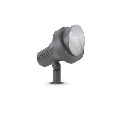 The Vespera Outside Large Single Spotlight in grey, mounted on a small adjustable base against a white background, boasts an IP65 rating and features a large lens. Its ribbed housing design aids in heat dissipation, making it perfect for durable outdoor lighting solutions.