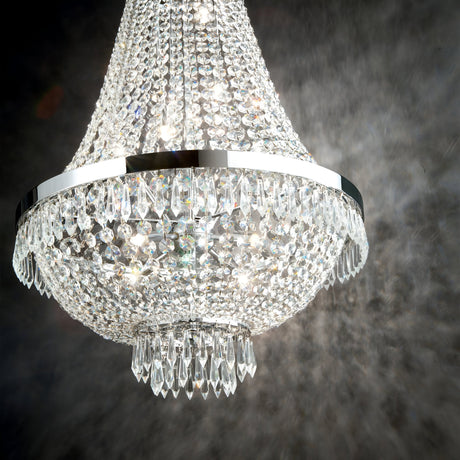 A close-up of the Silhouette Crystal 6 Light Chandelier - Chrome, featuring an elegant multi-tiered design and sparkling crystal elements, reflecting light beautifully. The chandelier is set against a dark background, highlighting its intricate craftsmanship.