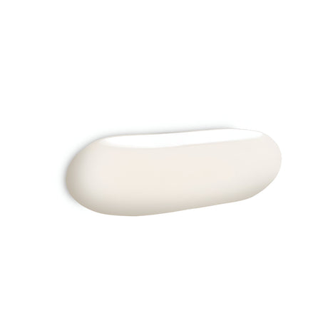 The Clip 2 Light Wall Light in white, featuring a minimalist oval design with a smooth surface, is mounted on a white wall. Its sleek appearance is enhanced by a chrome frame that seamlessly fits into modern interiors while casting a soft, uniform glow when illuminated.