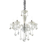 The Nimble Crystal 5 Light Chandelier in chrome exudes luxury with its five candle-like lights and cascading crystal prisms, all hanging elegantly from a decorative wrapped cord. It seamlessly combines classic elegance with a modern touch.