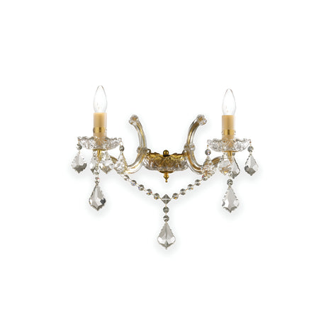 The Aurora Wall Crystal Light- Gold is a decorative sconce adorned with two candle-shaped bulbs and exquisite crystal accents. Its elegantly curved metal arms and dangling crystals evoke a classic yet luxurious aesthetic, making it an ideal gold wall light for any sophisticated setting.