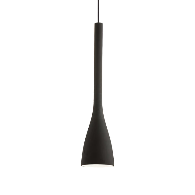 The Zenona 1 Light Large Pendant - Black is a contemporary fixture featuring an elongated design suspended from a slender cord. Its smooth, matte finish is accentuated when turned off, revealing its ambient light potential. The pendant's shape gracefully narrows from a wide top to a narrow base.