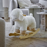 Laasrith Rocking Sheep in white, a curly fabric ride-on toy with sleepy embroidered eyes, floppy ears and wooden handle, set on poplar wood rockers in a living room.