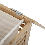 Close-up of the Aden Bamboo Laundry Basket's hinged lid corner, showing a metal hinge, slatted natural bamboo frame, and cream cotton liner against a white background.