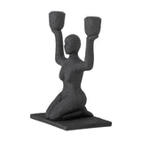 Lucie Resin Candle Holder in black, a textured kneeling female figure raising both arms to hold two cup-shaped candle sockets, on a rectangular base against a white background.