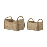 Selma Baskets Set of 2 in beige bankuan grass, rectangular bodies with loop end handles and braided corner trim, shown in two sizes on a plain white background.