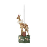 Flor resin giraffe candle holder in a party hat and ruff, on a green bunting base with a wrapped gift, holding a tall white candle, shown on a white background.