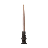 Hui stoneware candle holder in black with a turned profile, stacked rings, rounded centre and flared foot, holding a tall taper candle against a white background.