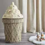 Cillie Seagrass Basket with Lid 72cm, ice-cream cone-shaped kids storage basket with criss-cross woven base and swirled sprinkle-dotted lid, shown in a nursery setting beside toys.