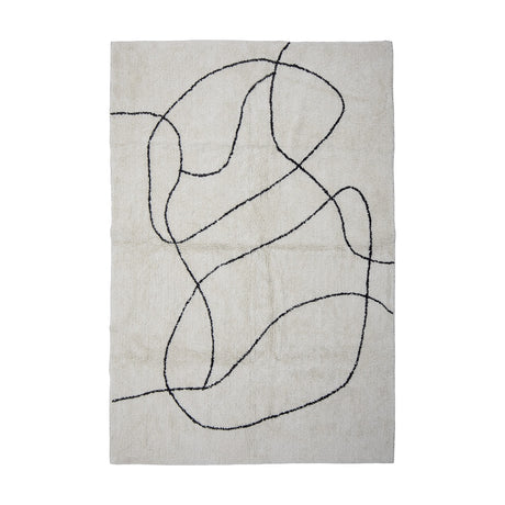 Viga Cotton Rug 180x120cm in white, a tufted rectangular rug with a continuous black freehand line looping across the soft, slightly shaggy surface, shown on a plain background.