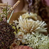 Close-up of the cream Chrysanthemum Artificial Stem's full bloom with layered pointed petals, shown among mixed dried-look florals in a neutral arrangement.