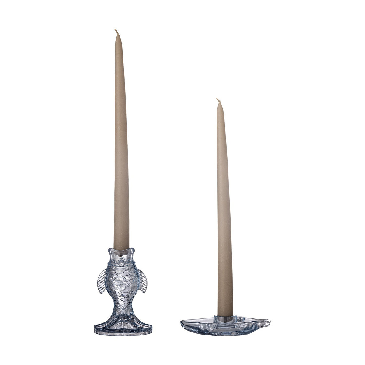 Linley Fish Glass Candle Holders in blue, one upright fish-shaped holder and one flat fish dish, each holding a tall taupe taper candle on a plain white background.