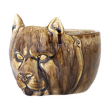 Abner Stoneware Plant Pot in brown, ceramic planter moulded as a big cat's face with pointed ears and relief features, glossy brown glaze, shown on a white background.