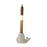 Hiro Fish Stoneware Candle Holder in grey, shaped like an upright fish with scaled relief, raised eye and curled tail, holding a brown taper candle on a white background.