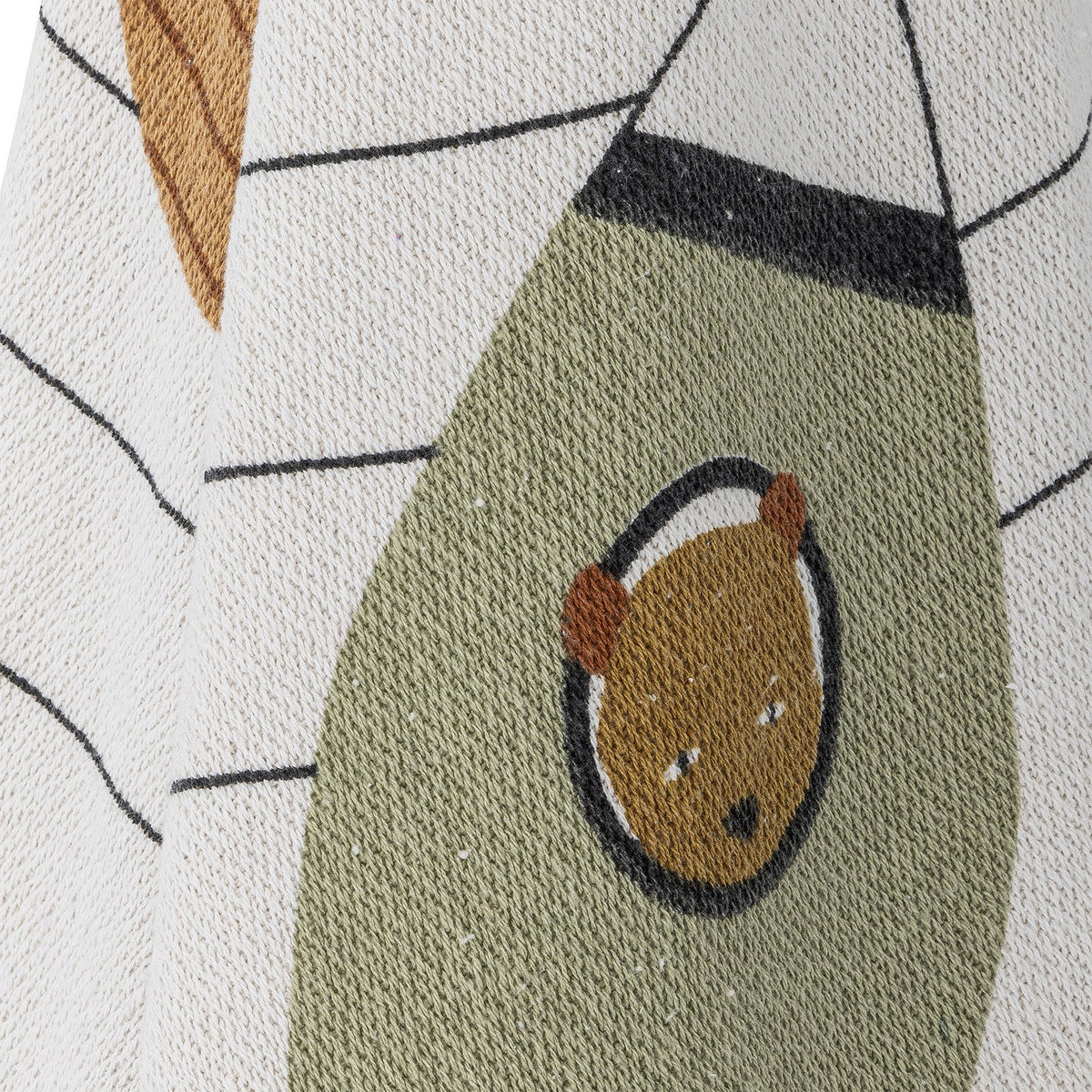 Close-up of the Space Cotton Throw in cream, showing a woven bear-in-helmet motif on an olive-green rocket shape with striped star details on the fabric.