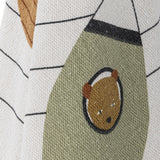 Close-up of the Space Cotton Throw in cream, showing a woven bear-in-helmet motif on an olive-green rocket shape with striped star details on the fabric.