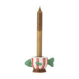 Codia Fish Stoneware Tealight & Candle Holder in white and red stripes with green fins, holding a tall brown candle on a plain white background.