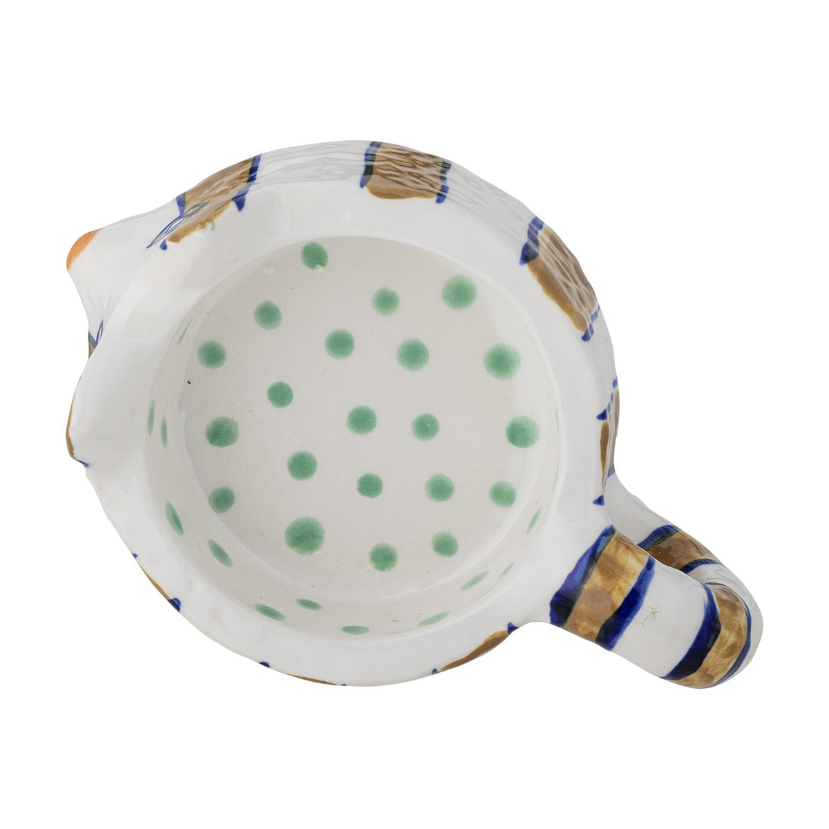 Overhead view into a cat-shaped stoneware candle holder's hollow bowl, white with green polka dots inside and gold-and-blue striped rim and handle, on a white background.