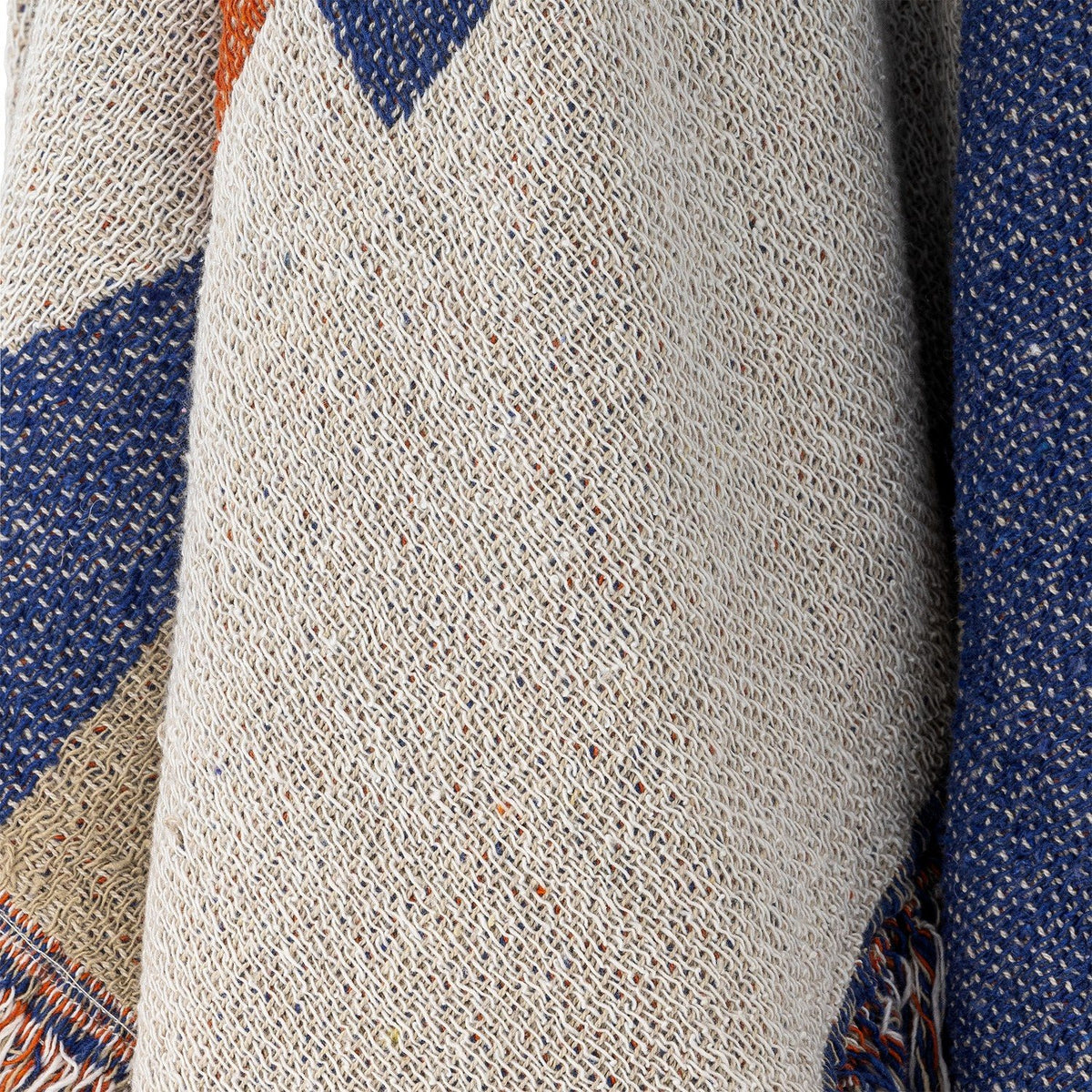 Clarita Cotton Throw in Multi, close-up of woven cotton fabric showing cream, blue and orange geometric pattern with fringed edge detail.