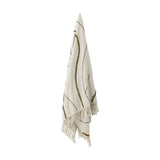 Osasio Cotton Throw in cream, hanging with tufted green and brown sweeping lines on a woven cotton ground, fringed edges, shown against a plain white background.