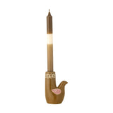 Trudy Bird Stoneware Candle Holder in glossy brown, bird-shaped base with painted pink wing and looped rim detail, holding a lit taper candle on a plain white background.