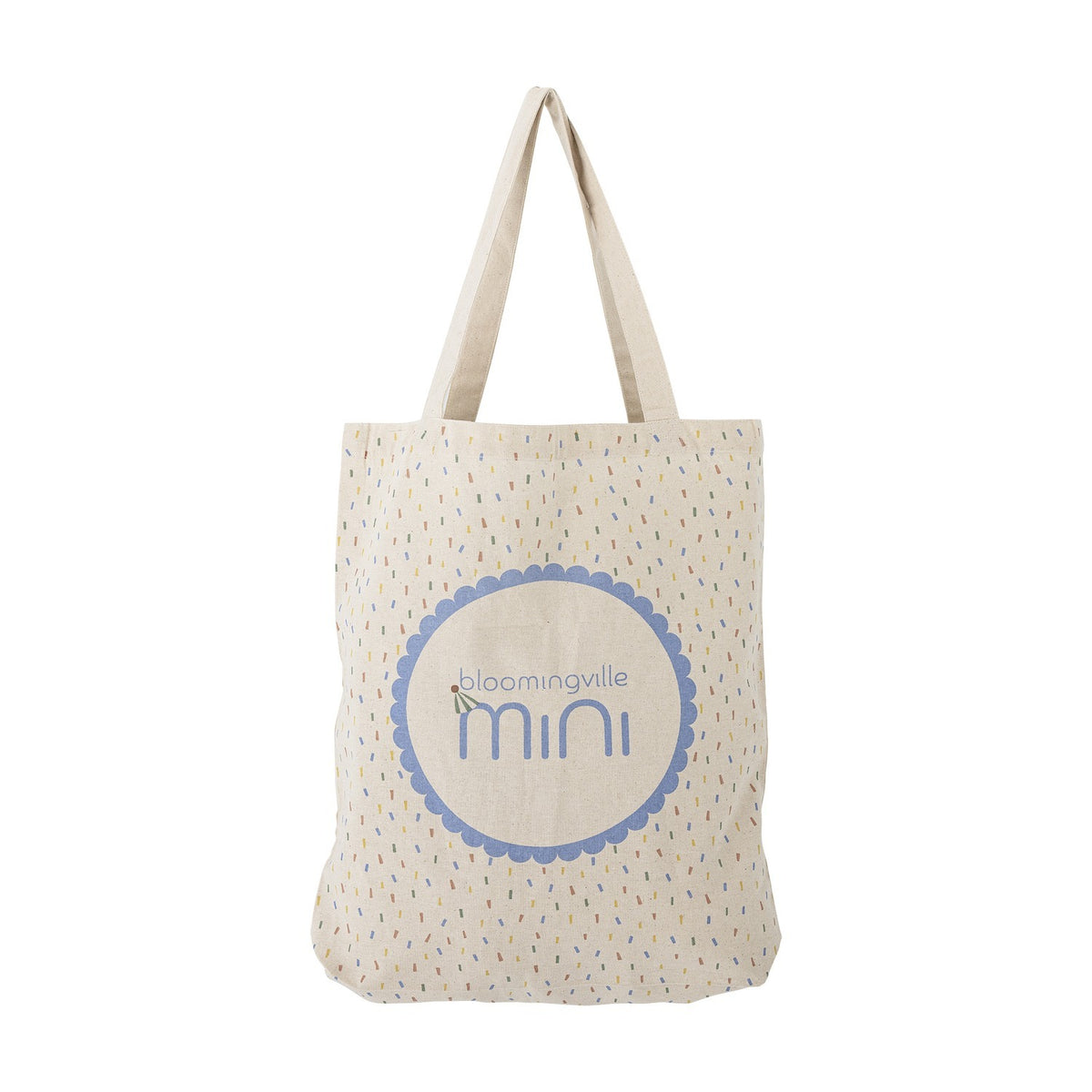 Celebrate Cotton Tote Bag in beige with twin handles, scattered confetti print, and a scalloped roundel logo on the front, shown on a plain white background.