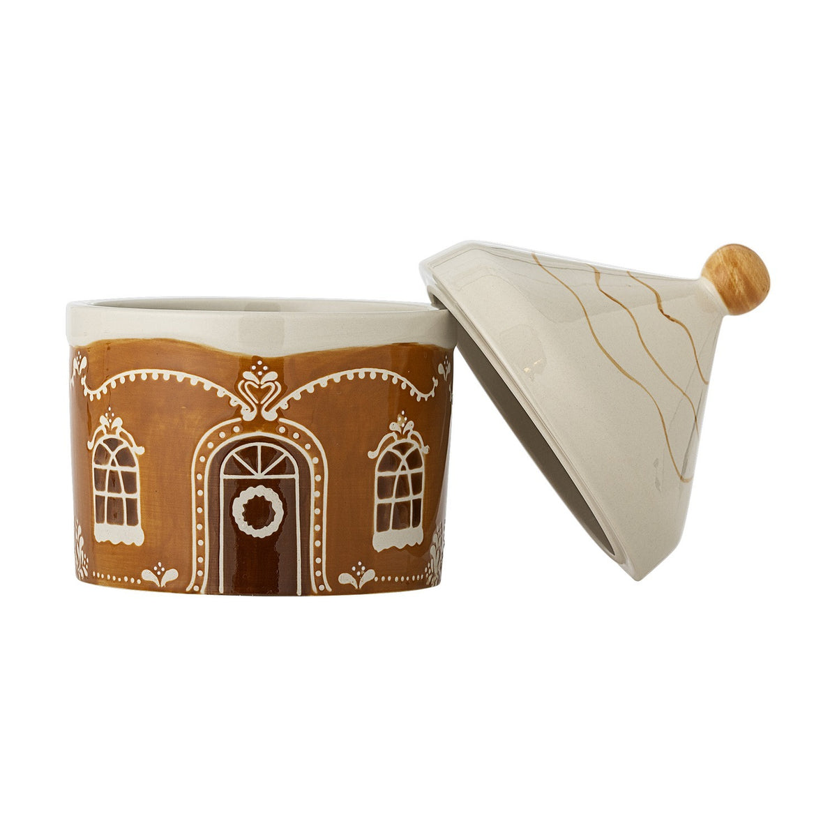 Gina stoneware Christmas storage jar shaped like a gingerbread house with hand-painted brown walls, arched windows, a wreathed door, and a cone-shaped lid with a round wood-toned knob, shown open.