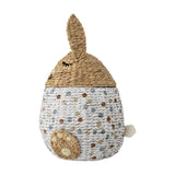 Villja Rabbit Water Hyacinth Basket with Lid in multicoloured, egg-shaped with braided rabbit head lid, upright ear, stitched eyes, paw detail and pompom tail, on a white background.