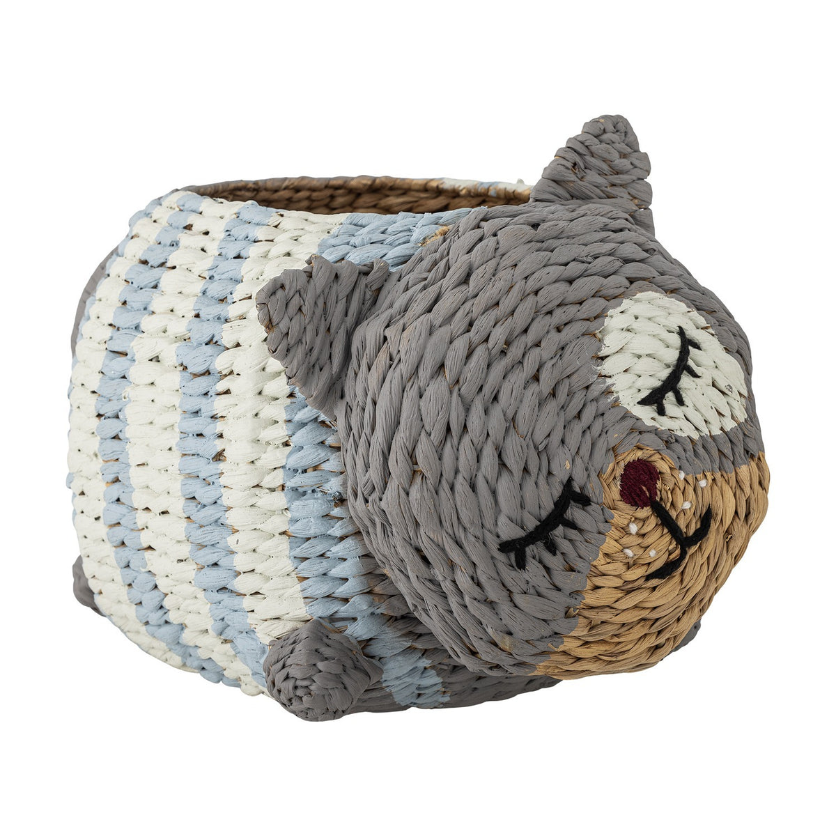 Mille Water Hyacinth Basket shaped like a sleeping cat with embroidered eyes, pointed ears, stubby feet and striped grey, cream and blue woven body on a white background.