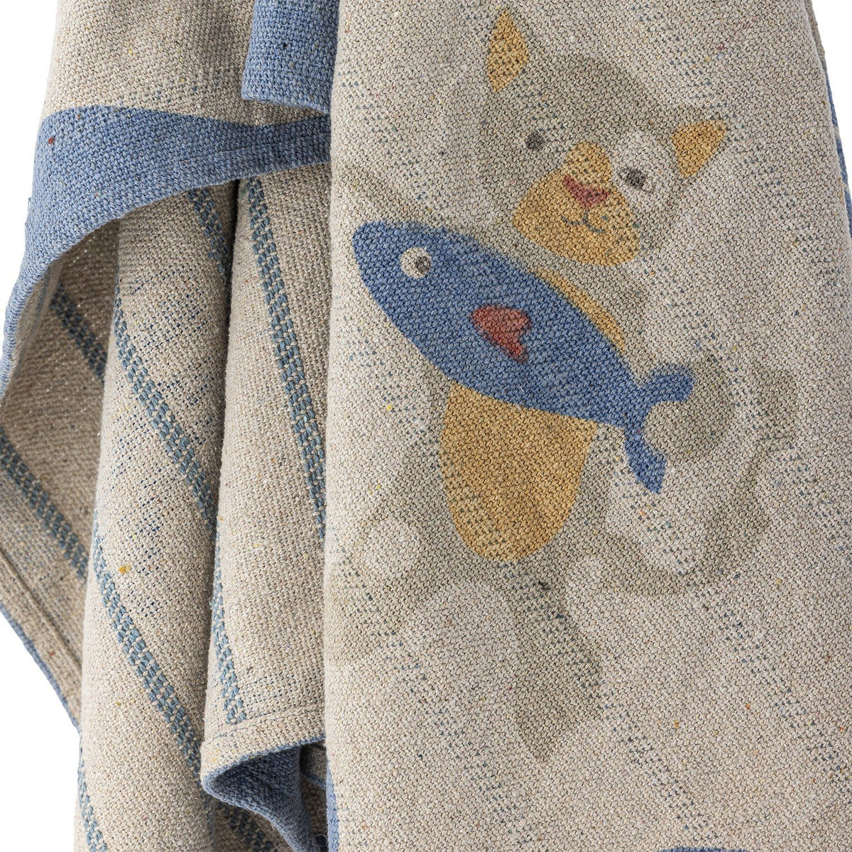 Mille Cotton Throw in beige woven cotton, close-up of a printed cat holding a fish design with a striped blue border and reverse side stripe detail.