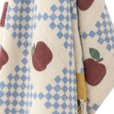 Gala Cotton Throw in Multi, a cotton throw woven with burgundy apples and blue checked panels on cream, with a mustard yellow border and knotted fringe.