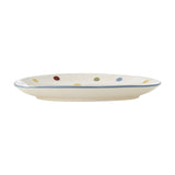 Side view of a cream stoneware kids' plate from the Party Dotted Dinner Set, with a blue rim line and multicoloured painted dots, on a white background.