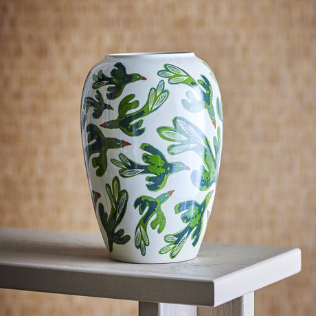 Birdliva Stoneware Vase 33cm in white with a green and blue bird-in-flight pattern, rounded shoulders and short rim, displayed on a wooden table against a woven backdrop.