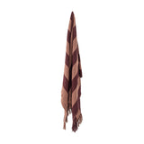 Frello Striped Cotton Throw in red, woven with wide diagonal stripes in light and deep red tones, finished with knotted fringe, hanging against a plain white background.
