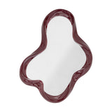 Violeta wall mirror with a glossy red resin frame rippling into soft rounded lobes around the glass, shown on a plain white background.