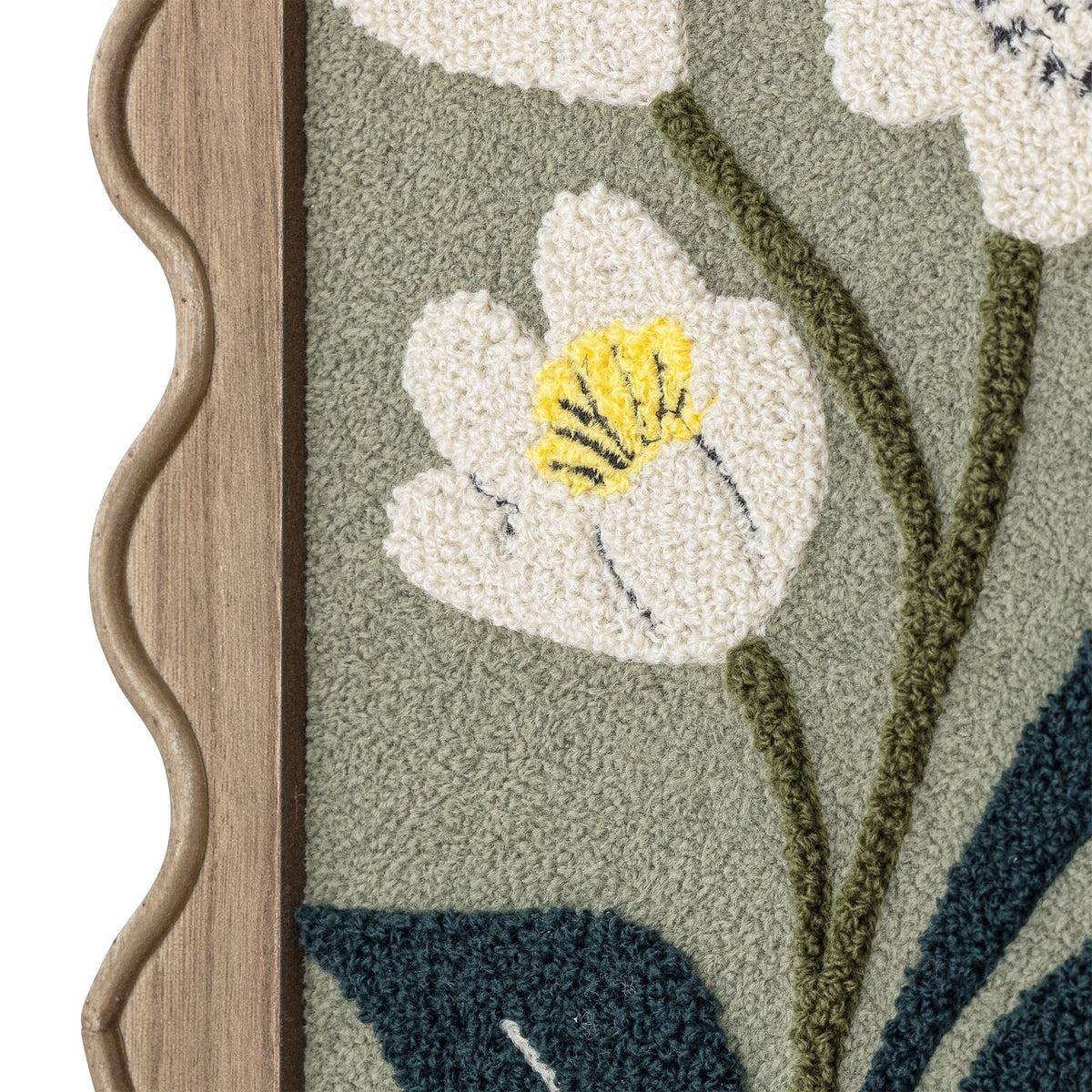 Talan Wavy Framed Print close-up showing tufted white flower with yellow centre, green stems and dark leaves on sage background, set in a wavy-edged wooden frame.