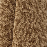 Close-up of the Kaysa cotton bath towel in brown, showing its soft looped pile with a textured, curling pattern in lighter and darker brown tones.