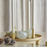Maxime Iron Christmas Candle Holders Set of 7 in gold, round textured tray with slim tube holders, styled with white taper candles, mosaic baubles, pine cones and extra mini holders.