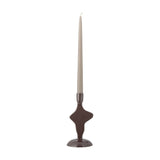 Cidra Aluminium Candle Holder in brown, a small abstract taper candle holder with glossy powder-coated finish and domed round base, shown with a beige candle on a white background.