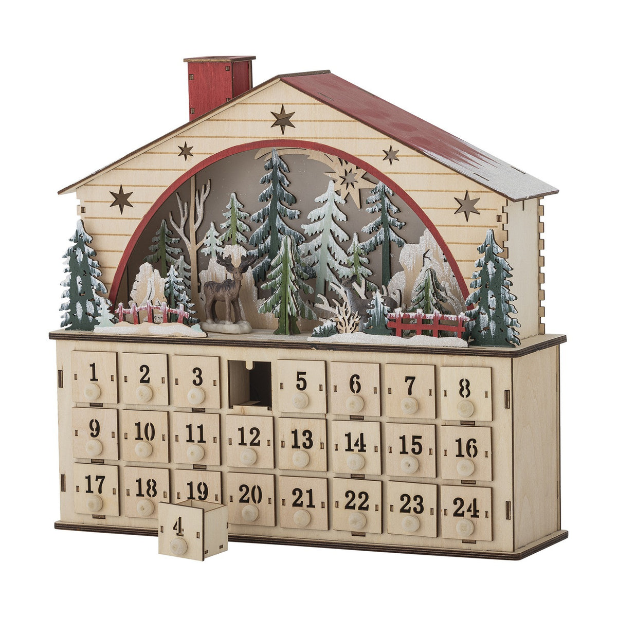 Wooden house-shaped advent calendar in beige plywood with red roof, star cut-outs, a lit winter forest scene with a deer, and 24 numbered drawers on a plain white background.