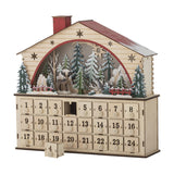 Wooden house-shaped advent calendar in beige plywood with red roof, star cut-outs, a lit winter forest scene with a deer, and 24 numbered drawers on a plain white background.