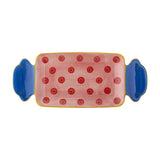 Caramella stoneware serving platter shaped like a wrapped sweet, with blue twisted ends and a pink, red polka-dot centre, shown on a plain white background.