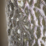 Close-up of the Eunice Stoneware Vase 37cm in white, showing its deeply pitted, coral-like surface pierced with irregular open holes and an uneven rounded rim.