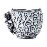 Malina Floral Stoneware Plant Pot in blue with a crinkled, textured surface and raised floral and leaf detail on one side, shown on a plain white background.