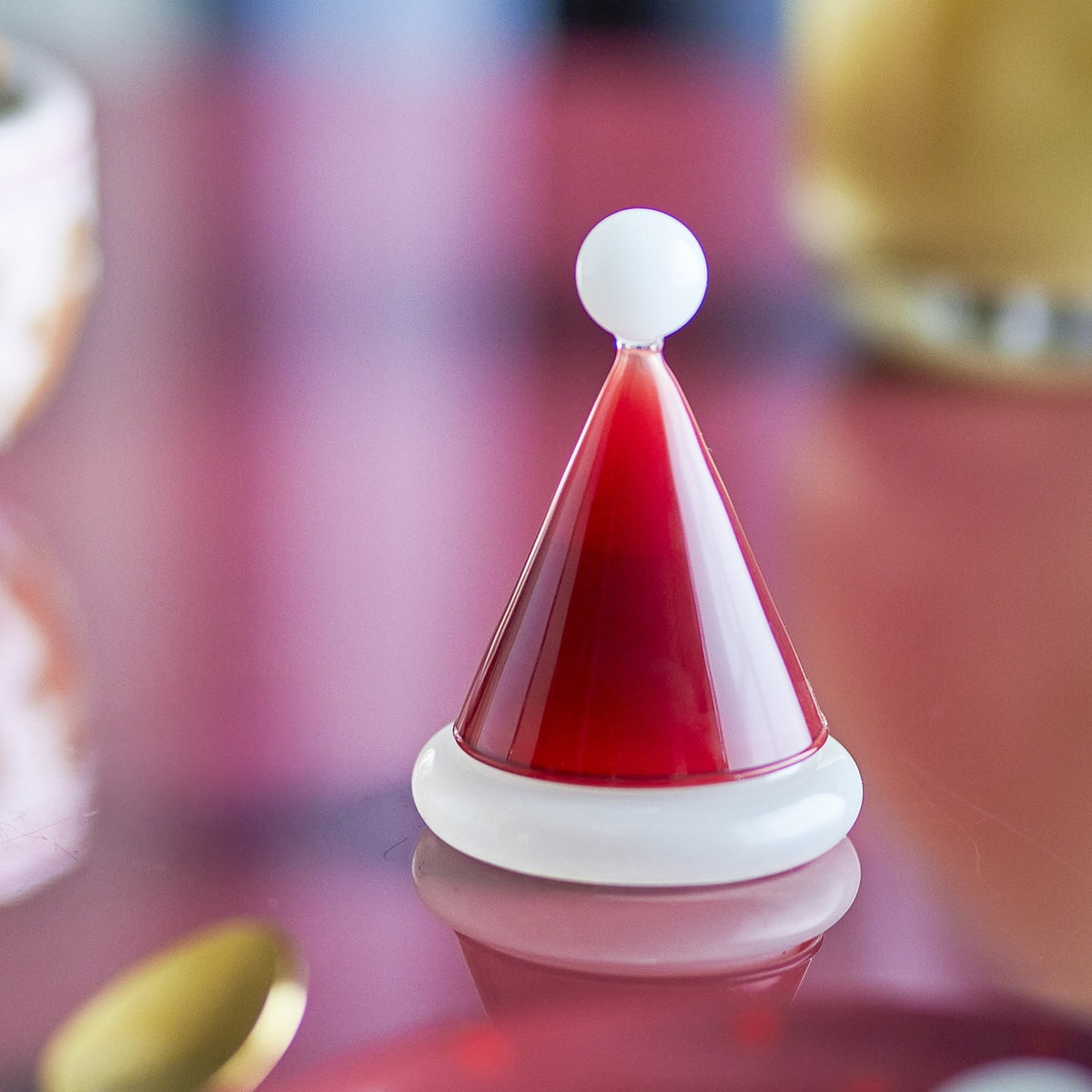 Patrice Glass Christmas Toothpick Holder in red, shaped like a Santa hat with a glossy cone lid, white bobble tip, and rolled white-rimmed base.