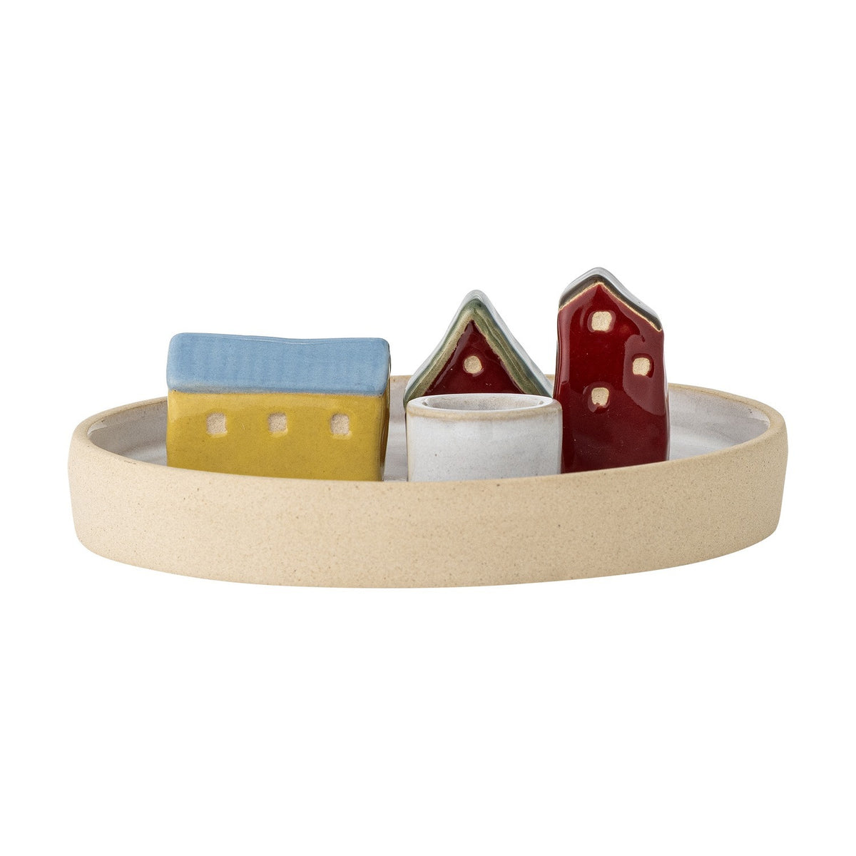 Coze round stoneware candle holder with three glazed house shapes in blue, yellow, red, and white on a shallow beige rimmed base with a central taper cup, shown on a plain white background.