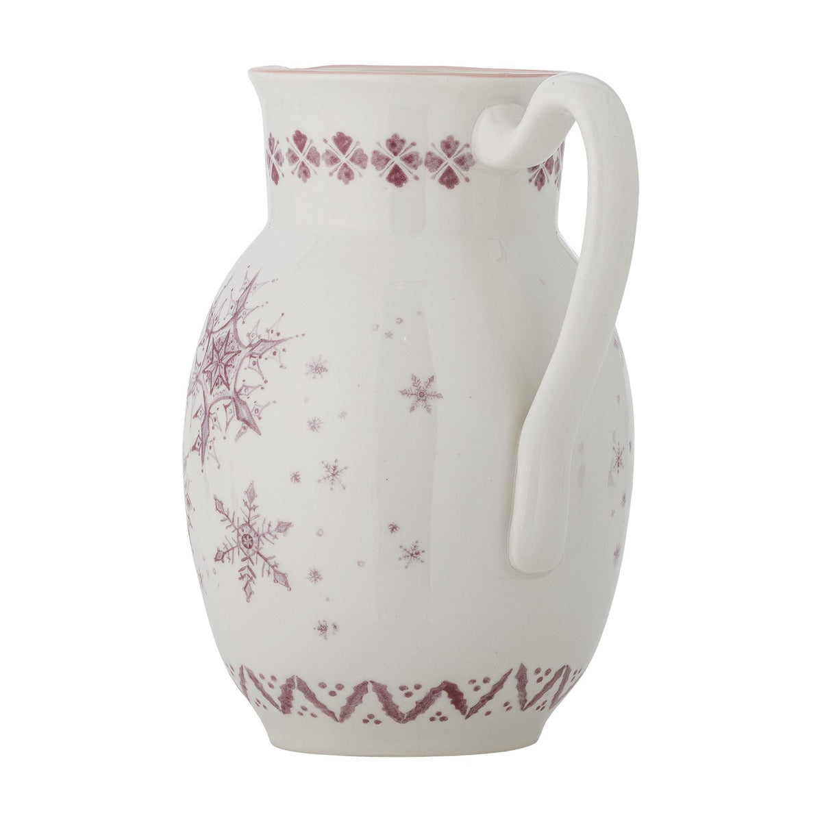 White stoneware Christmas jug with rounded body, pouring lip, and looped handle, decorated with pink-toned snowflake patterns and patterned borders, on a plain white background.