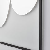Close-up of the two rounded forms meeting on the glass, the slim black frame crossing behind where they overlap.