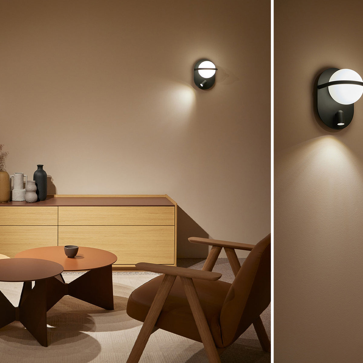 C-Ball W 2 Light Glass Sphere Wall Light in black with white glass sphere and base spotlight, shown illuminating a living room wall above furniture.